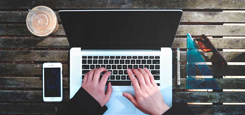 Person typing on a laptop computer.